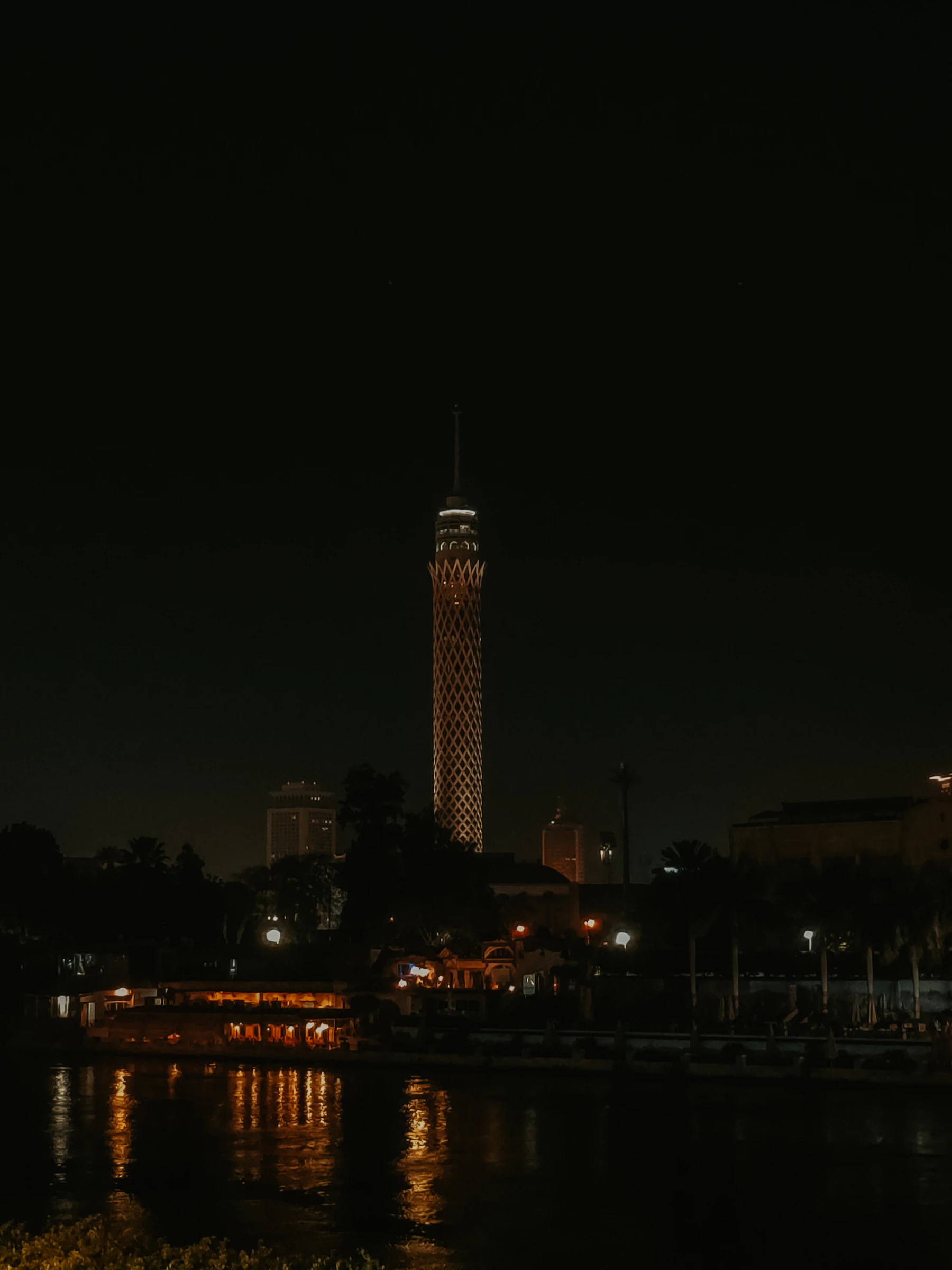 Cairo Tower lit at night above the Nile