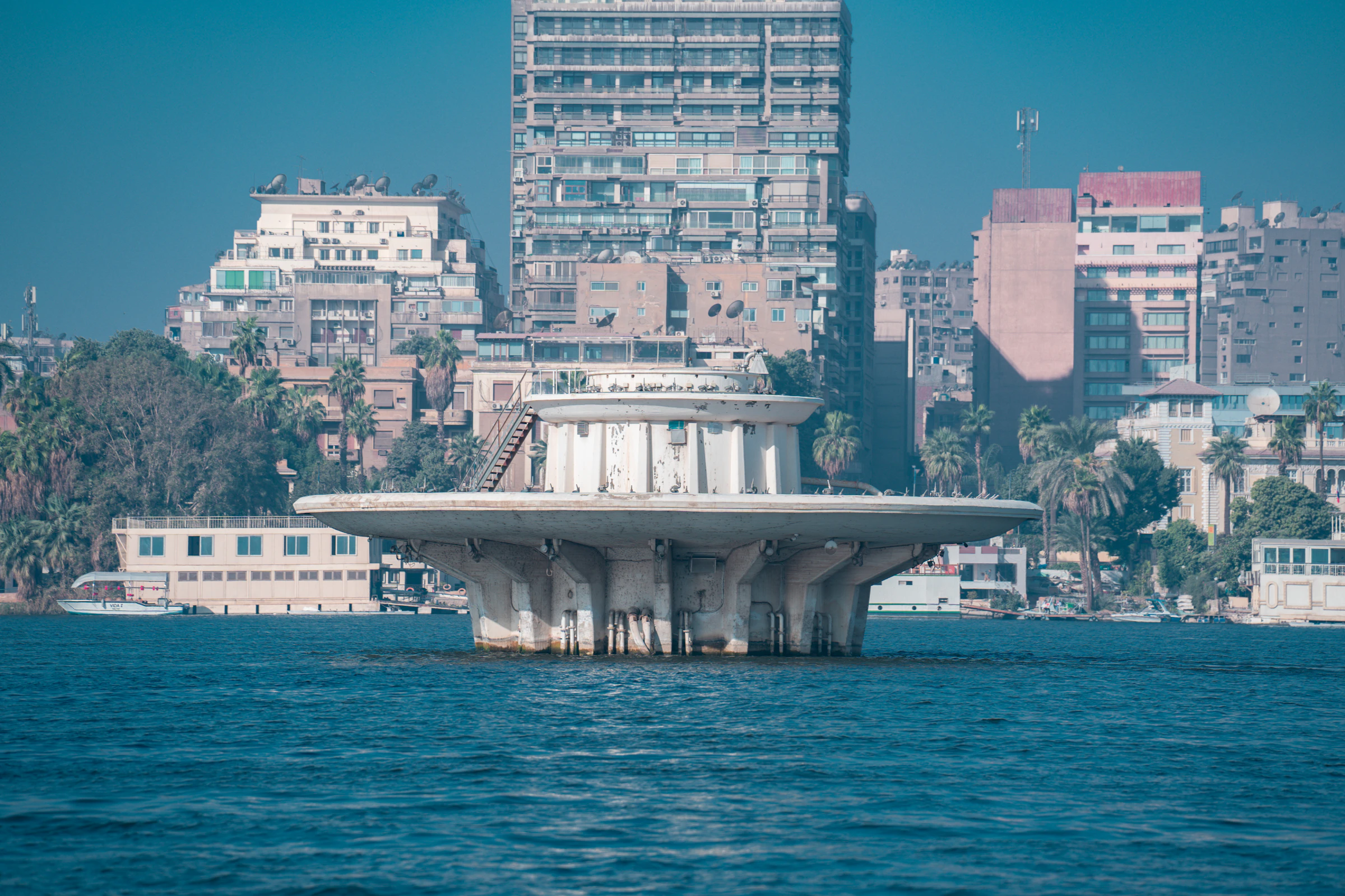 A round pavilion on the Nile in front of Cairo apartment towers