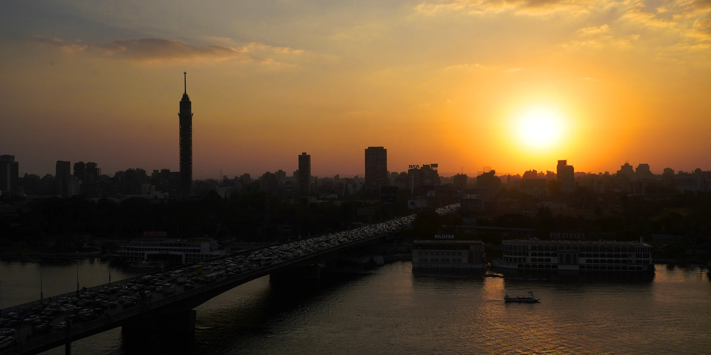 Sunset over Cairo Tower and a Nile bridge